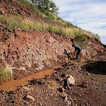 Continuous chip sampling of trenched road cut, east-side of Mexican Hat hill